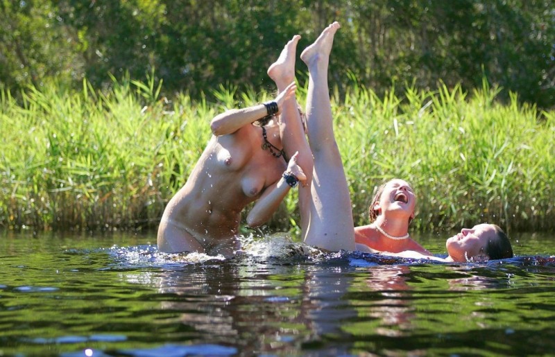 Women swim in the nude river