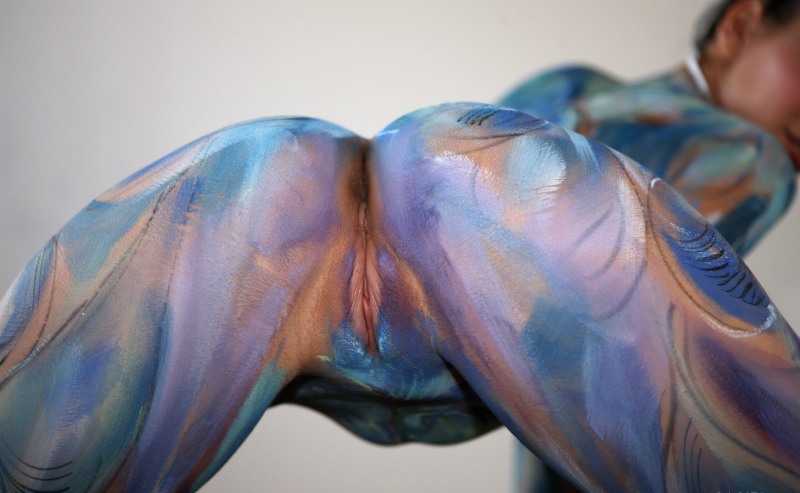 Naked women painted with paints