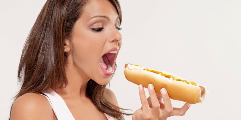 Girl eats a hot dog