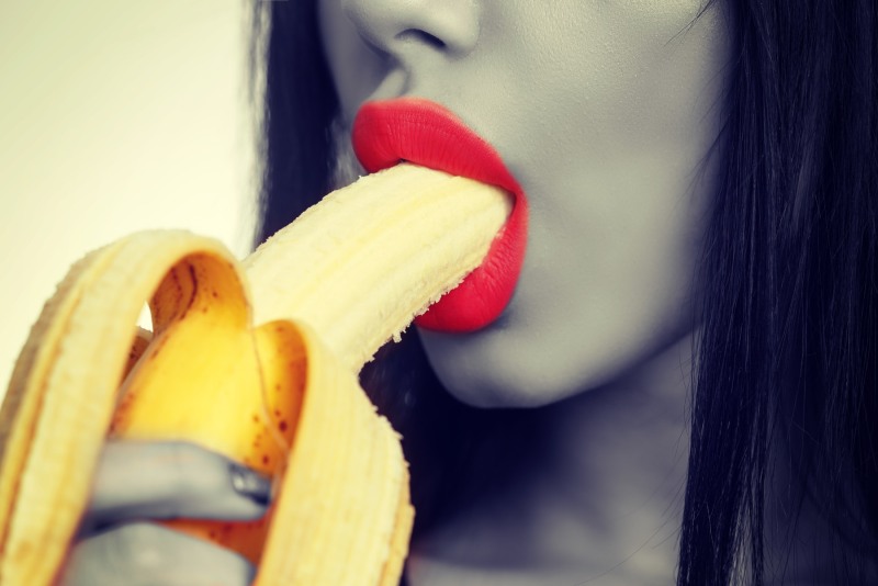 Girl with a banana in her mouth