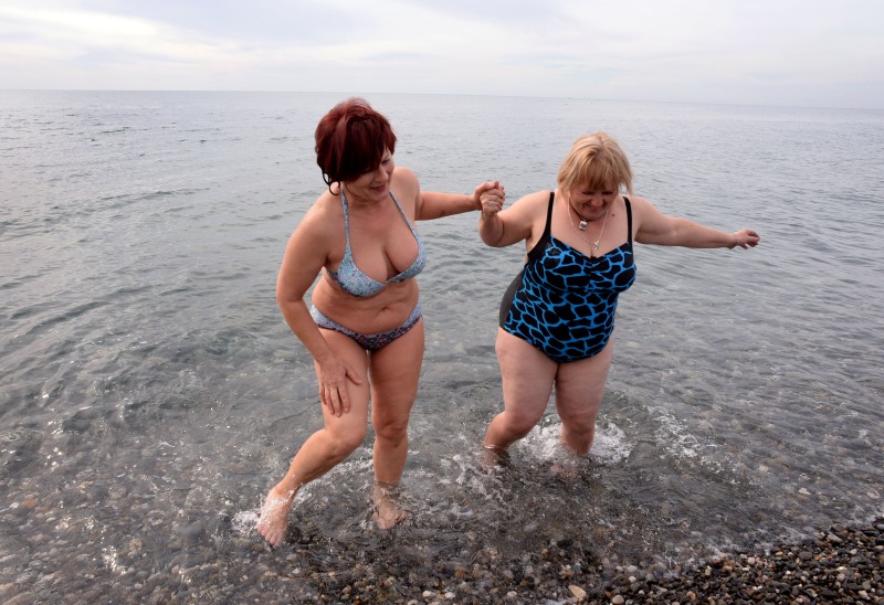 Fat grandmothers in swimsuits in the country