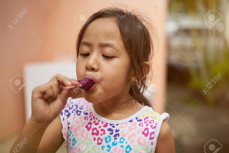 The girl licks ice cream