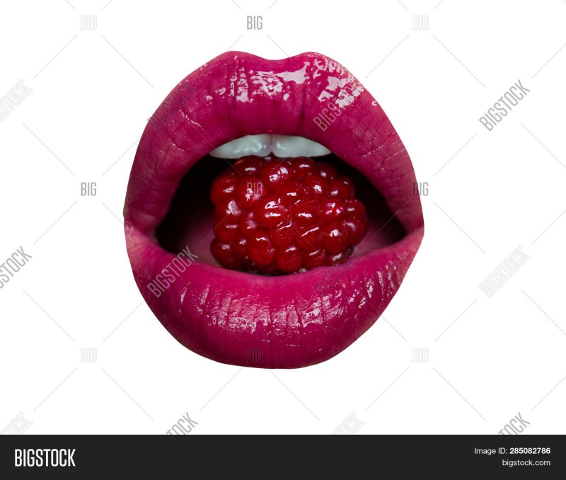 Lips with raspberries in the mouth
