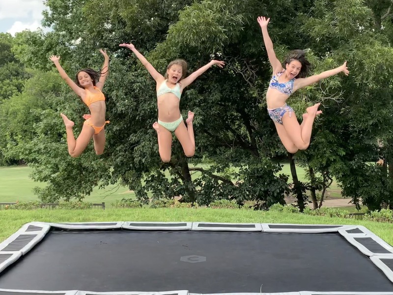 Naked women jump on a trampoline