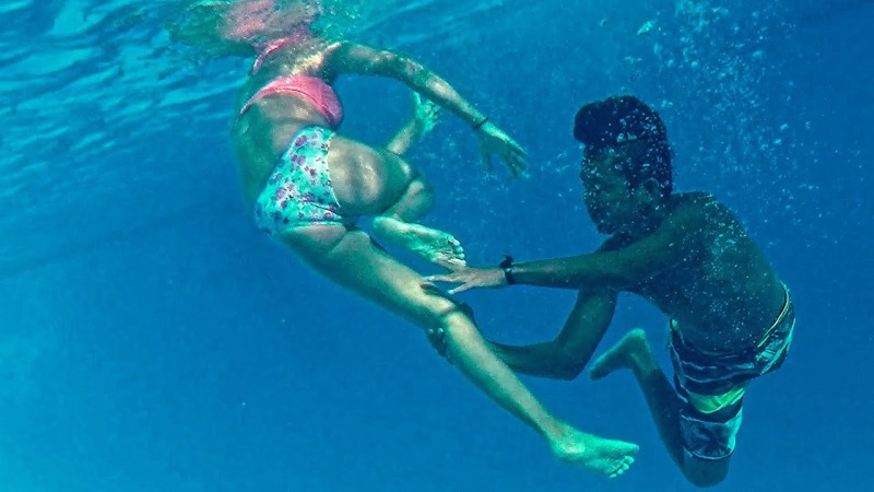 The girl is floating under water