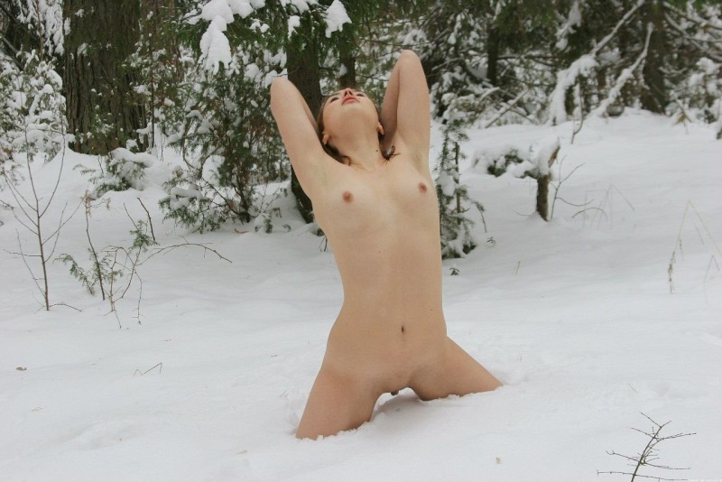 Naked women lie in the snow