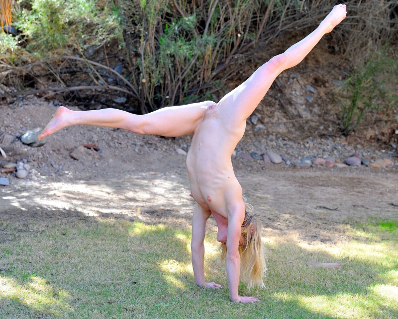 The girl is suspended by the legs of BDSM