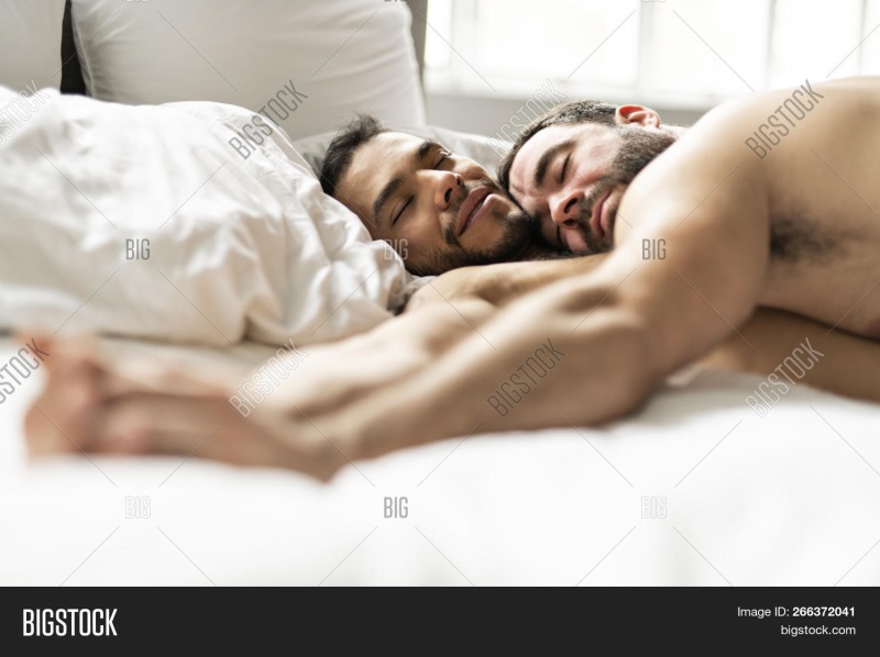 Men hug in bed