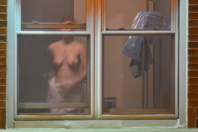 Naked women in the windows of houses