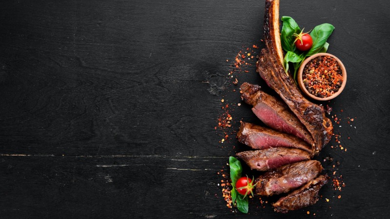 Steak on a black background from above
