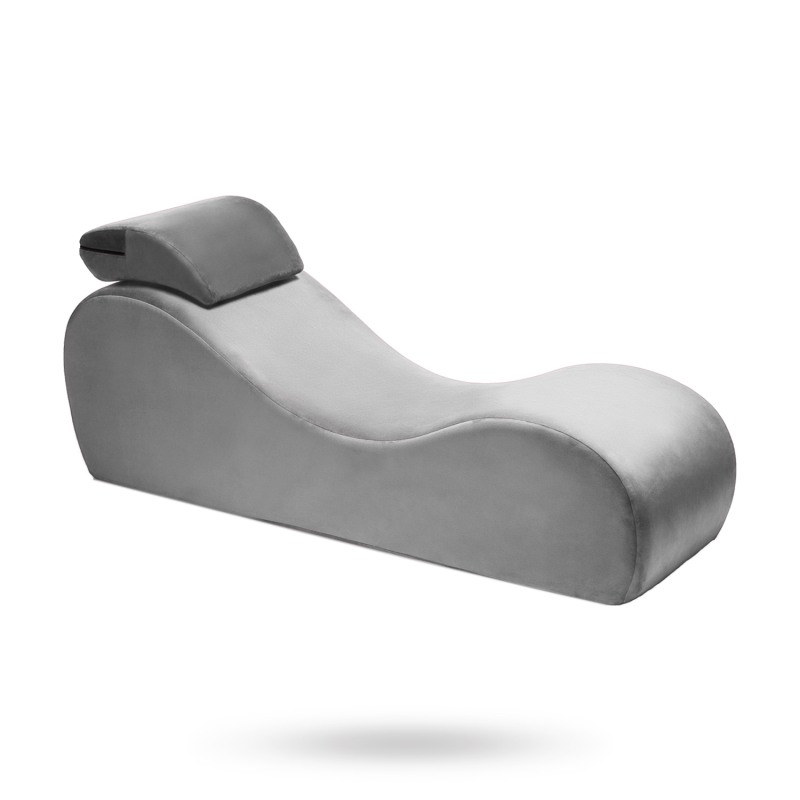 The girl lies on a sun lounger on the beach